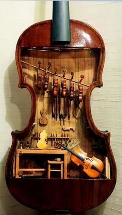 This 18th-century violin makers shop by W. Foster Tracy, 1979, is a miniature built inside a full-size violin. It was on display