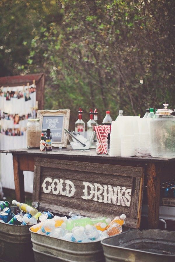 Vintage tin tubs for cold drinks and DIY sign for backyard wedding