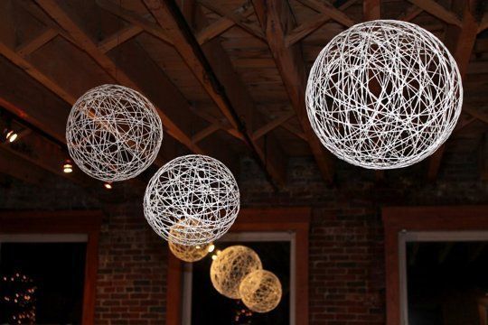 15 Cheap DIY Wedding Decorations These string balls would make a beautiful touch to an evening wedding.