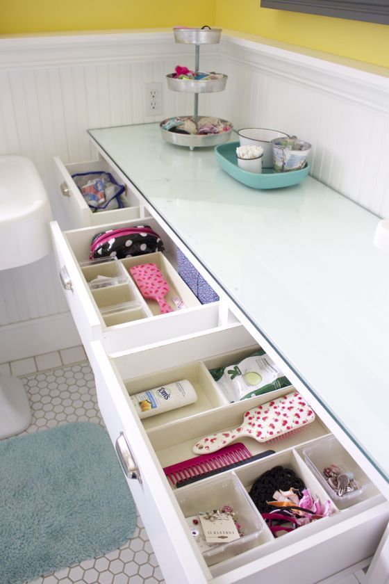 an organized kids bathroom. Use small bins in drawers to catch hairbands and other kid stuff.