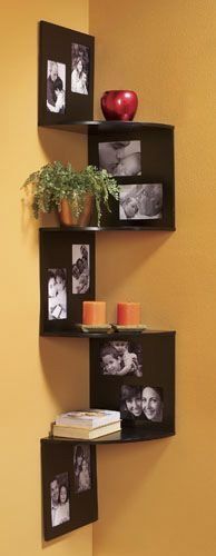 corner shelves with matching picture frames on either side (above-left, then underneath-right) the whole length of the shelf space