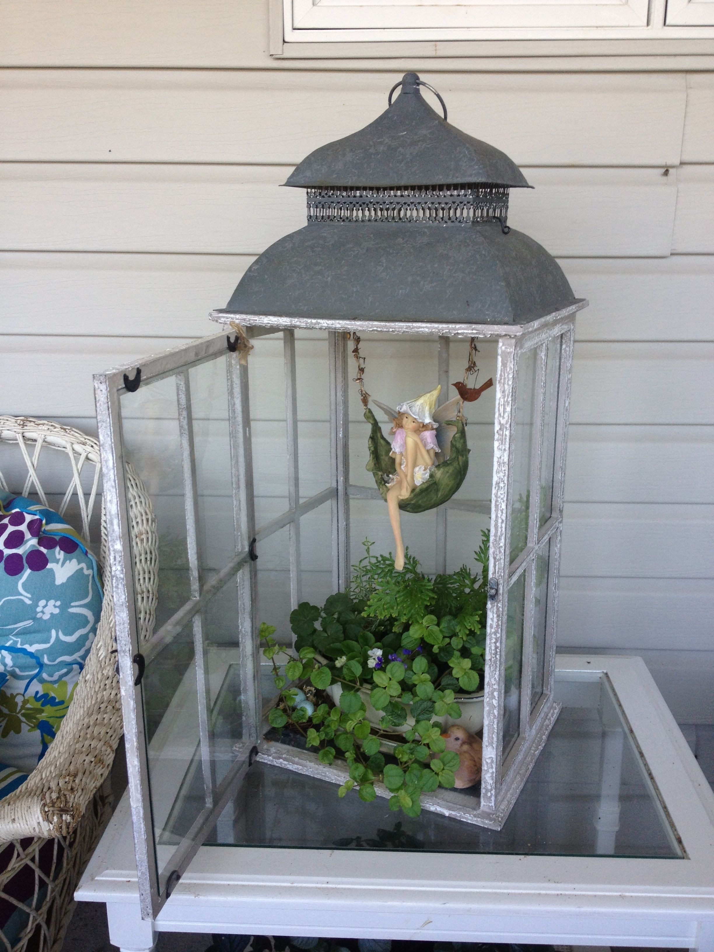 Faerie Garden in a lantern!  I already have a black wrought iron stand with 3 lanterns too …