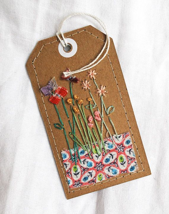 Hand-stitched pretty label on brown card using vintage embroidery cotton, and some wonderfully colourful vintage feedsack.