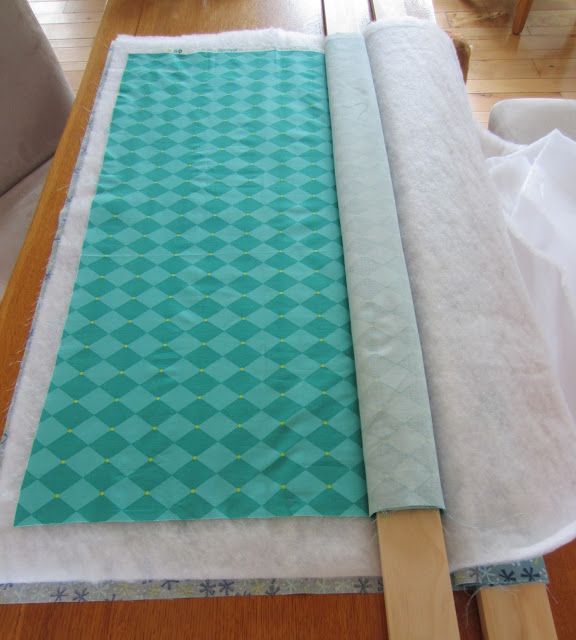 How to baste a quilt with two 1″x3″ boards. No kneeling, can be done on a dining room table. Genius! I soooo needed to know this!