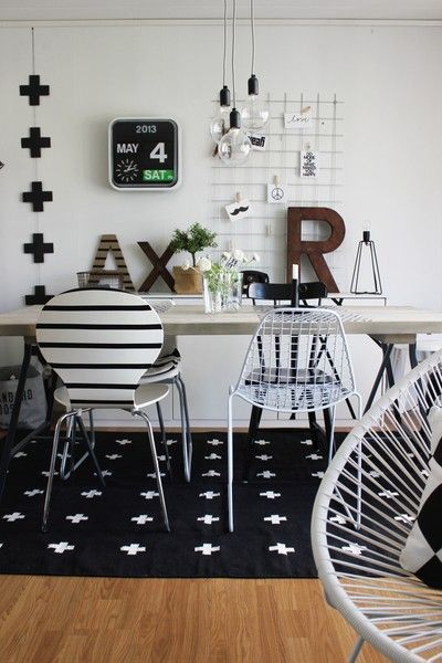 Inspiration & Design. Black and white interior. Plus signs. Graphic rug. Bertoia chairs.