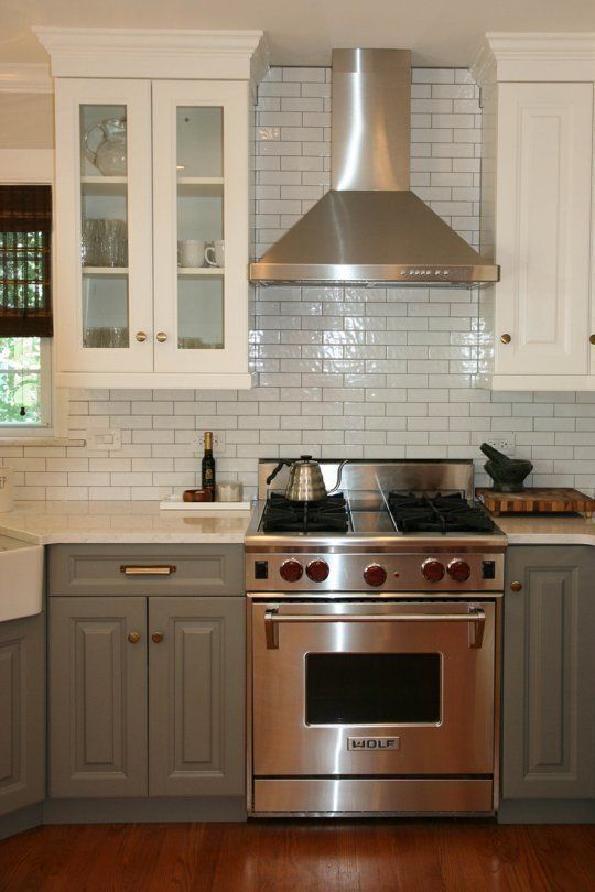 love the range, range hood, two-tone cabinets… basically everything! (upper and lower different finishes, glass front uppers)