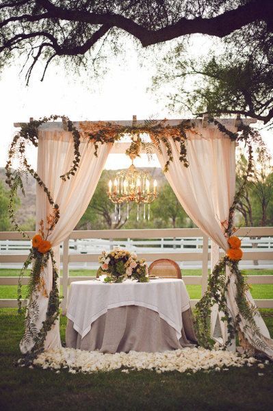 Rustic Wedding Reception – Chandelier and Curtains around the Sweetheart Table for the Bride and Groom
