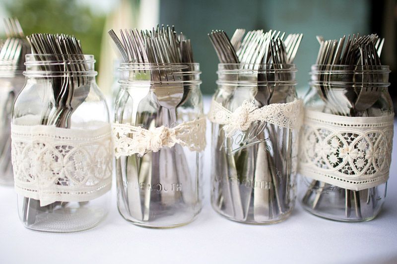 silverware in lace-wrapped masons. perfect with blue sheer ribbon instead of lace – work into centerpieces for each table?