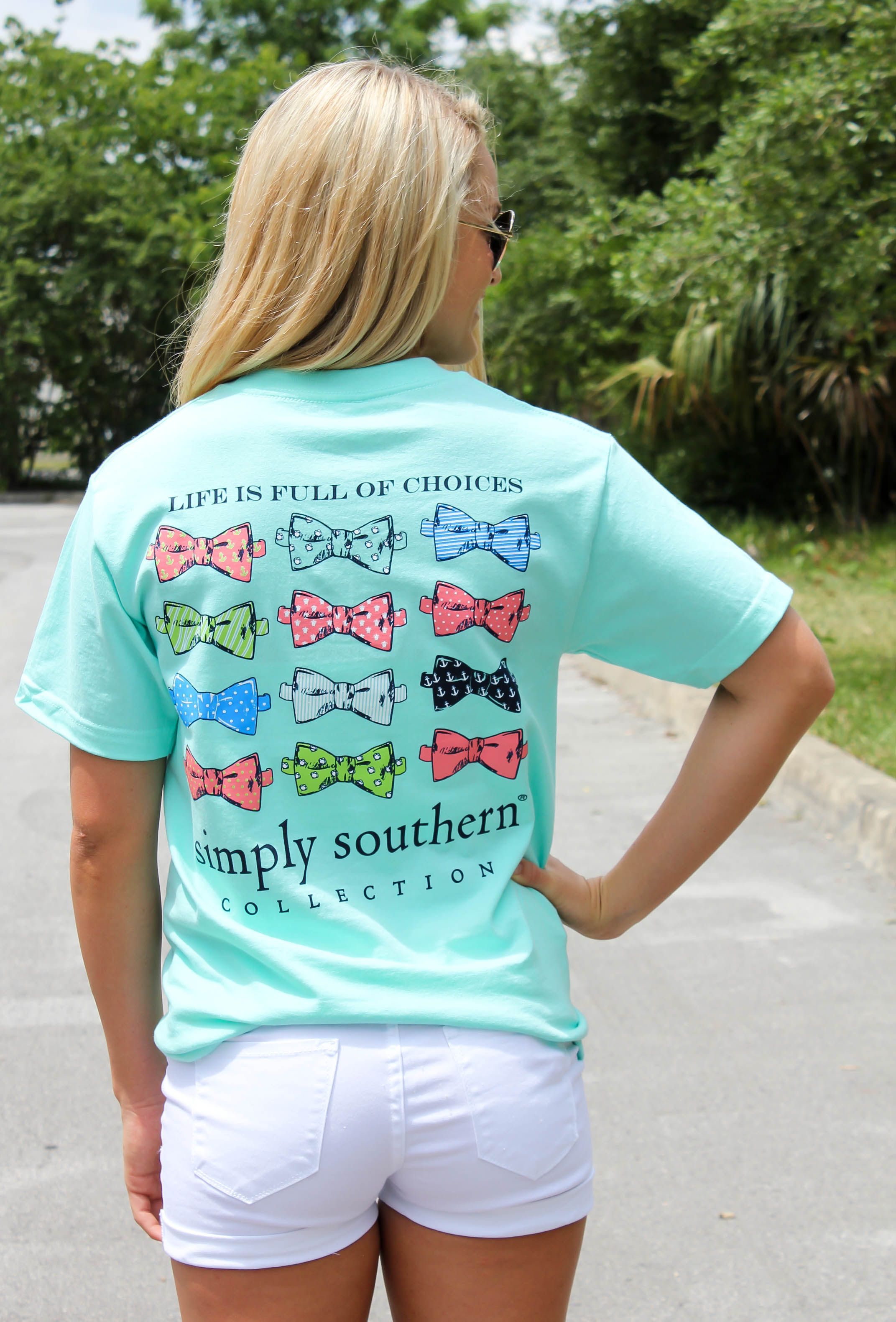Simply Southern is a preppy T-shirt collection. “Life is full of choices” with bowtie screen print. Model is 55″ wearing a small