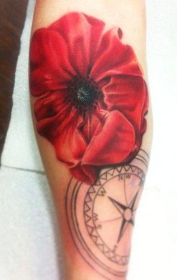 Tattoo of a red poppy and compass.