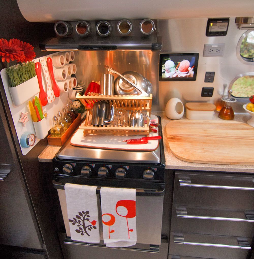 The kitchen setup in this Airstream trailer is to DIE FOR. That magnetic wall for utensils is brilliant!