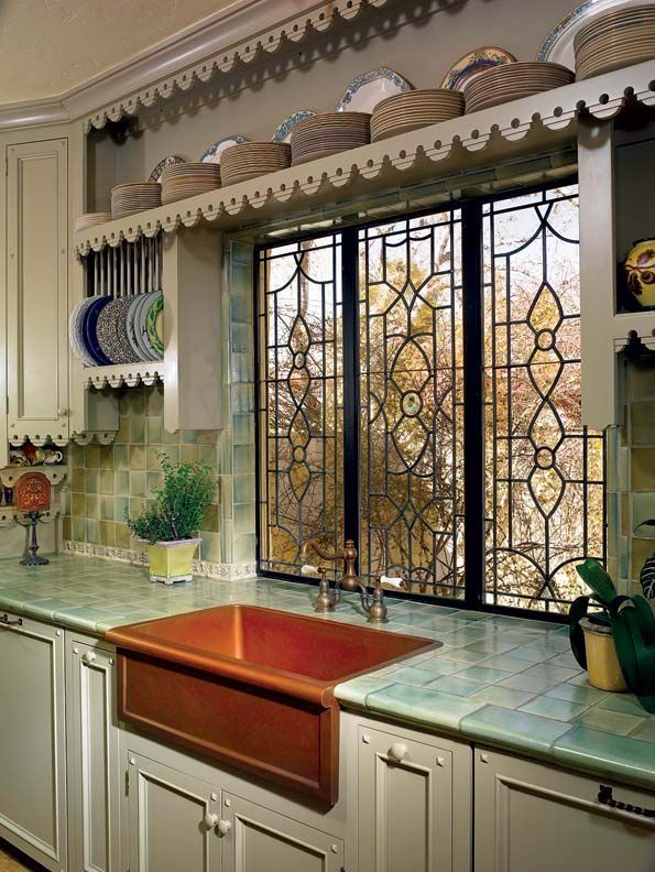 This stunning kitchen remodel has custom designed leaded glass windows, copper farmhouse sink, salvaged tile backsplash,  and