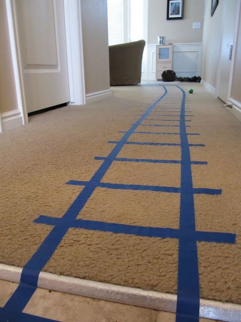 Use painters tape or masking tape to make easily removable train tracks! Great for rentals or your own home.