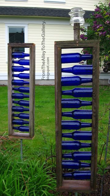 What a cool use of blue bottles. I wish there were red bottles too. Than I could make the Acadian flag out of them! #garden