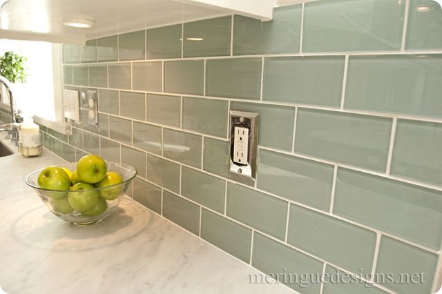 White marble counter w/ green subway tiles.  I like the stainless outlet covers.  The rest of her kitchen is GORGEOUS.