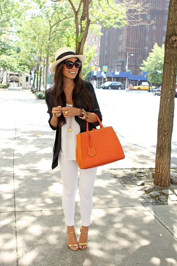 White skinny jeans, white top, dark blazer, gold accessories and a pop of color with the handbag.