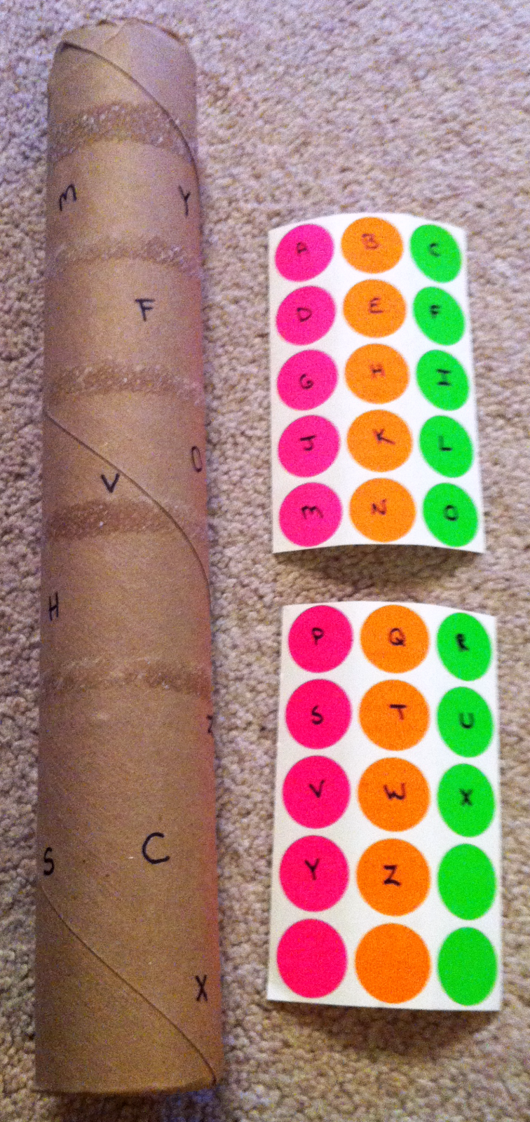 Write letters on tube and on stickers; kids have to match the stickers to the letters on the tube.