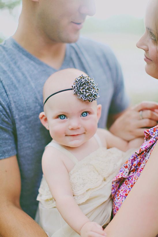 baby looking at cam, mom and dad looking at each other.  great capture of her blue eyes