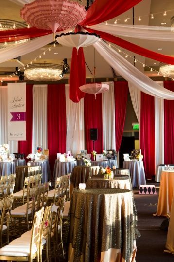 Ballroom decked out in Vintage Circus decor with dramatic drapes  Get Hitched, Give Hope
