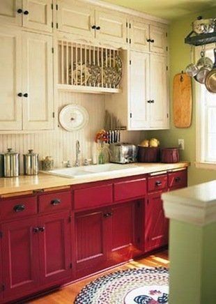Dont be afraid to switch up your paint colors. The cranberry-colored base cabinets and cream wall-hung units add a dramatic look