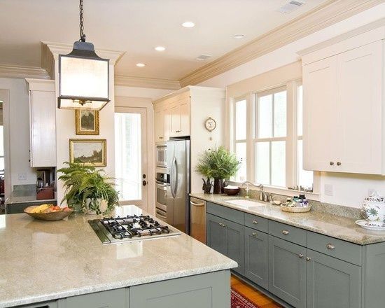 Gorgeous dark duck egg blue on the bottom cabinets with a stunning lantern over the island.