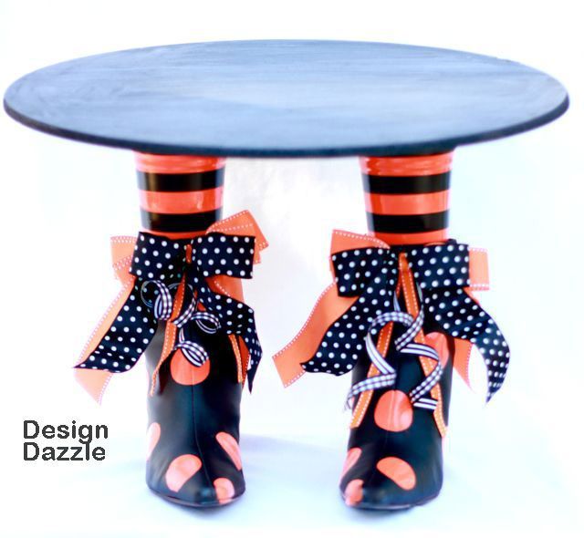 How cute is this cake stand?  Thrift store boots spray painted and Plastic cups for legs … Love it!  #Halloween