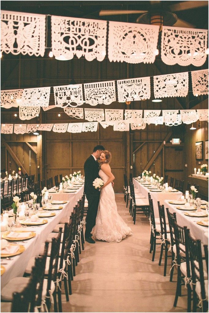 Mexican gold, ivory, white, pink wedding inspiration with white papel picado, long feasting tables with DIY lace runners