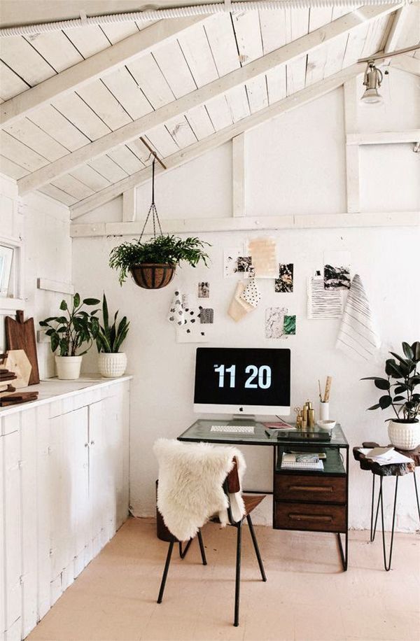 those potted plants and hanging basket fern give this minimalistic white office a breath of fresh air.