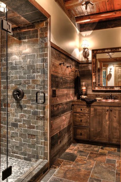 Barn wood walls, alder cabinets, slate tile and river rock tile & a frameless clear glass shower door.