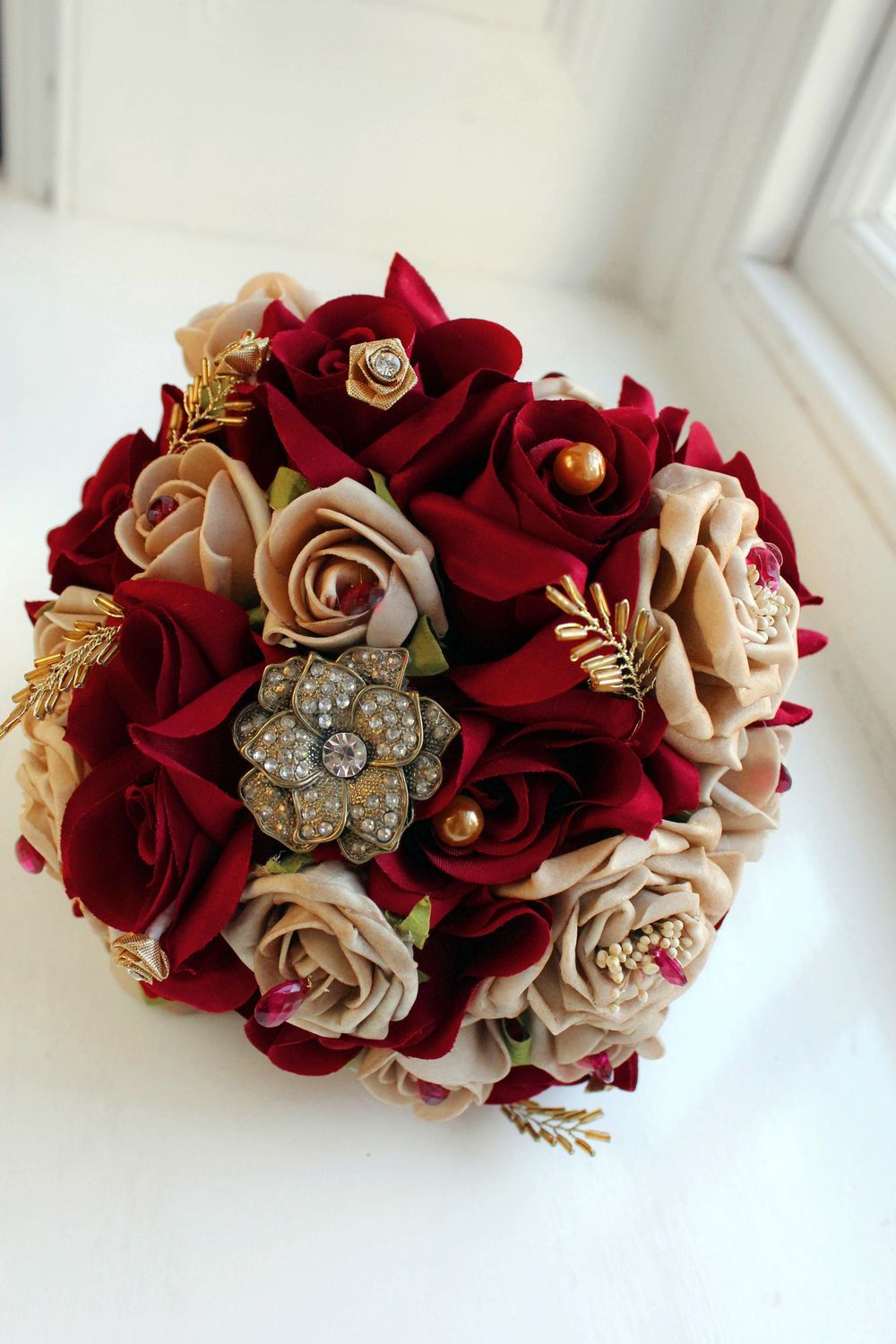 Beautiful red and gold wedding bouquet with jewels!