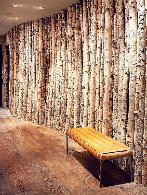Birch trees lining this hallway were adhered to the plywood wall, covered in a light coat of plaster, with hidden screws. The team