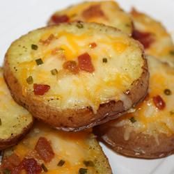 Cheesy Bacon Potato Rounds. Ingredients: 4 baking potatoes, cut into 1/2 inch slices; 1/4 cup melted butter; 8 slices bacon –