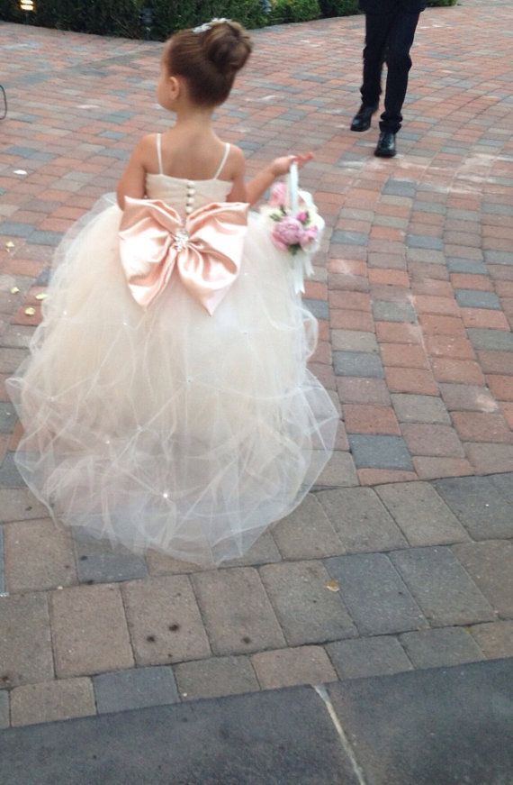 Glamorous tulle flower girl dress with a pink bow for a flower girl princess