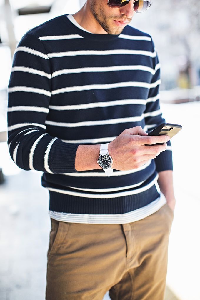 Great men’s outfit for warm weather: striped sweater, khaki joggers, silver watch, aviator sunglasses. .