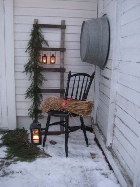 Husfruas Memoarer: winter porch display with an old ladder with hanging lanterns and greenery. Blog is not in english but she has