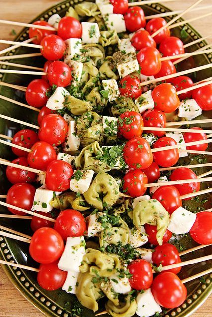 quick and easy appetizer – skewered cherry tomato, fresh mozz, and spinach tortellini drizzled with pesto