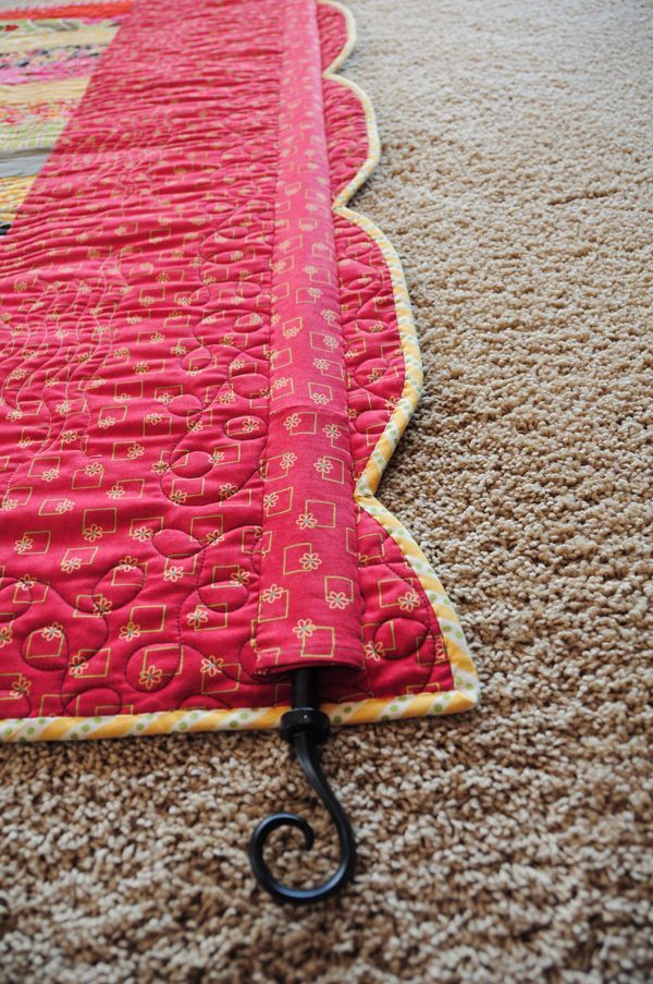 Sew a rod pocket on the back of a quilt. Slide a decorative curtain rod through the pocket and hang it up to display.