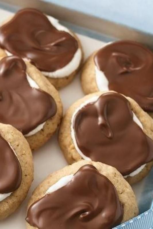 Top homemade graham cracker cookies with marshmallows and chocolate to make s’mores!