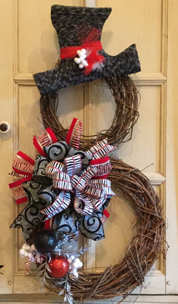Totally awesome snowman grapevine wreath for winter and Christmas. Made with black, white, and red, fun and funky holiday wreath.