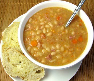 White Bean and Ham Soup  1/2 tbsp olive oil  1/2 yellow sweet onion  1 cup of carrots sliced  2 stalks of celery sliced  1 clove