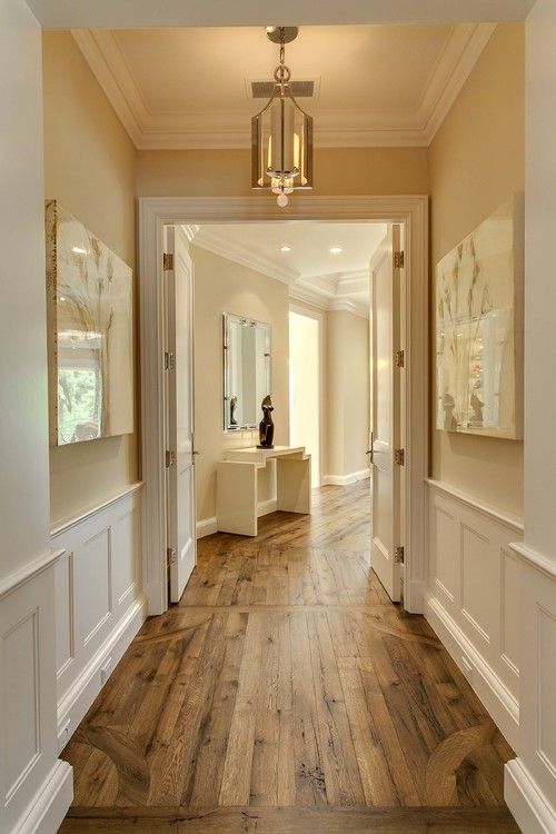 Hallway with great wood floors, molding and cream walls, very pretty….