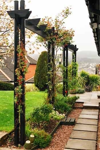 This long, narrow arbor adds vertical interest to the garden.