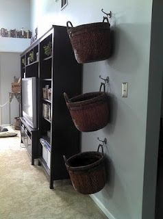 Hang baskets on wall of family room for blankets, remotes, and general clutter.