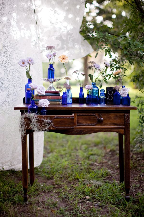 different vases/jars and mixed flowers + furniture outside!! + lace backdrop! So