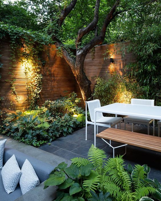 a contemporary townhouse garden with stone tiles, minimalist furniture ... - Elaine -   9 garden design Minimalist trees ideas
